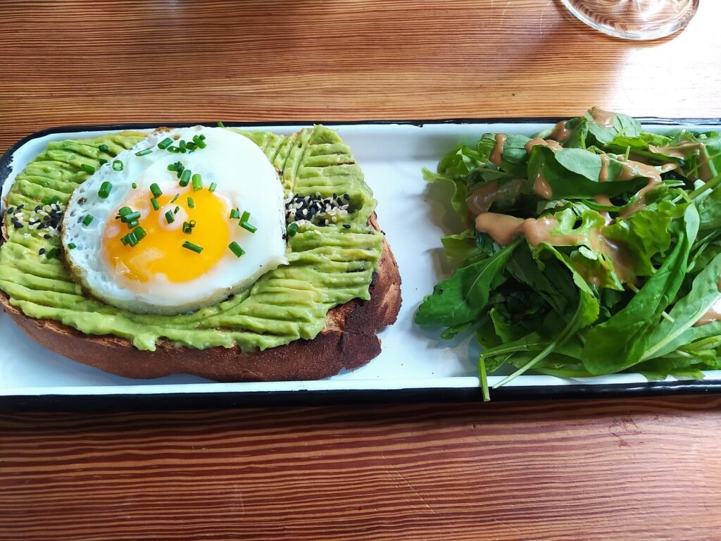 Avocado toast with a green salad on a brunch plate