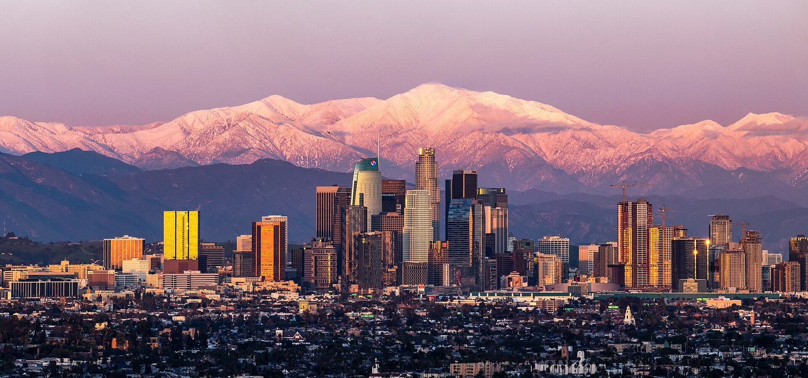 Downtown Los Angeles skyline with snow on Mount Baldy behind it