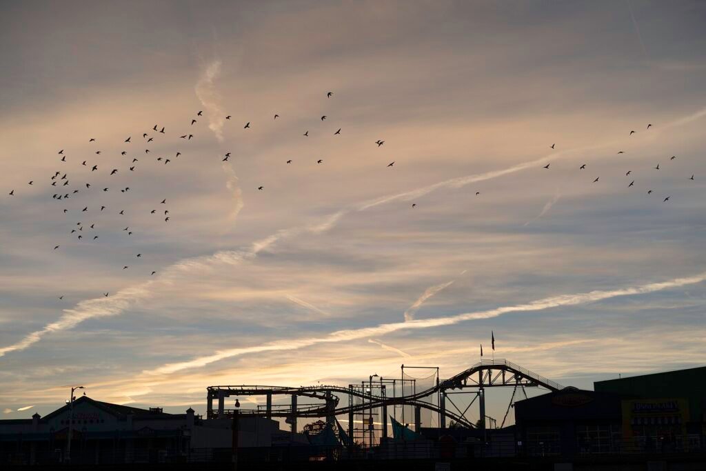 Silhouette of the roller coaster at Santa Monica Pier at sunrise